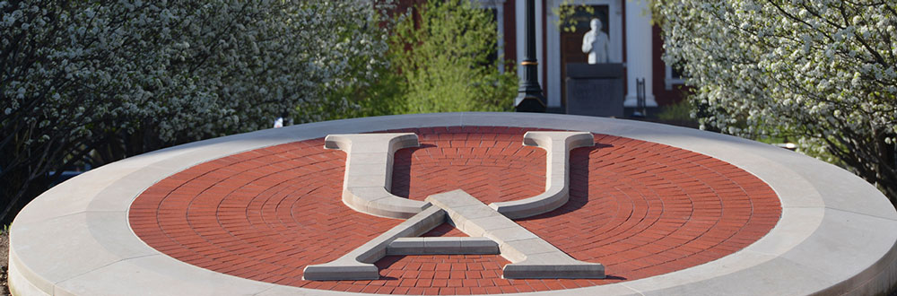 A decorative ϲҳ in stone is located in the center of campus.
